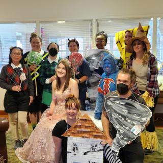A lively group dressed in creative costumes for a themed event, showcasing their fun and festive spirit.