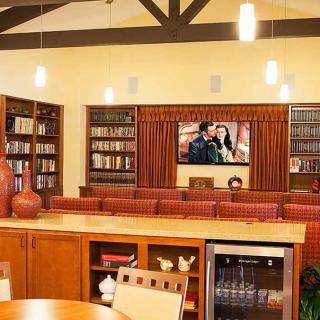 A cozy library interior with bookshelves and a television for entertainment.