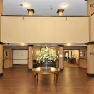 A welcoming lobby area with a central table adorned with flowers.