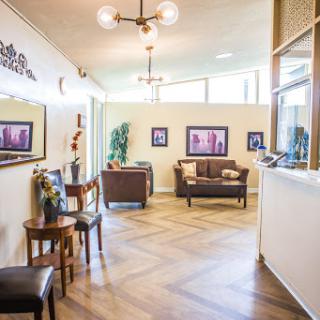 A stylish waiting room featuring comfortable seating and modern decor.