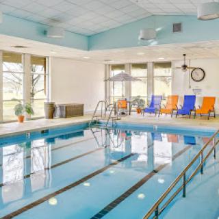 A bright and inviting indoor swimming pool area, perfect for relaxation and fitness activities.