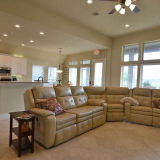 A spacious open-concept living room and kitchen area with comfortable seating.