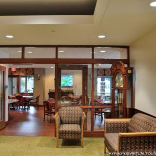 A view of a lobby area with comfortable seating and wooden decor.