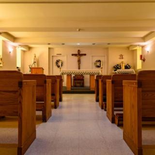 Interior view of a church with pews and an altar.