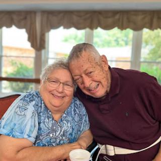 A joyful moment shared between two elderly friends, showcasing their bond and happiness.