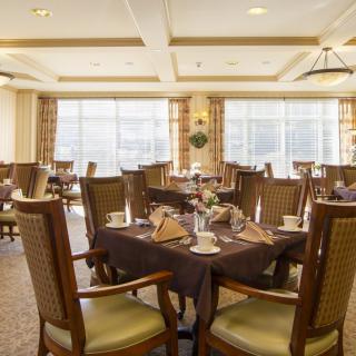 An elegant dining room with neatly arranged tables and chairs, ready for guests.
