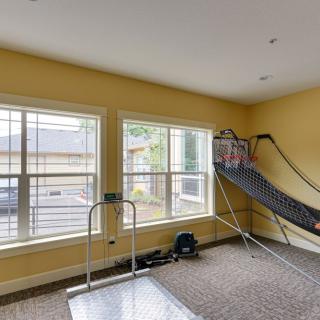 A room with exercise equipment and an indoor basketball game setup.