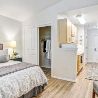 A modern and minimalist bedroom with bright decor and a cozy atmosphere.