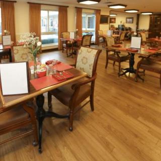 A cozy restaurant interior with neatly arranged tables and chairs, ready for diners.