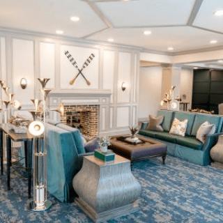An elegantly designed living room with plush sofas, a decorative fireplace, and stylish furnishings.