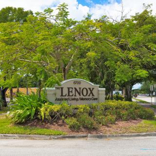Entrance sign to Lenox community surrounded by lush greenery.