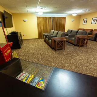 A cozy lounge area featuring comfortable seating and a television.