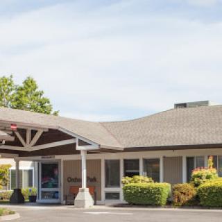 A welcoming entrance to a well-maintained building surrounded by lush greenery.