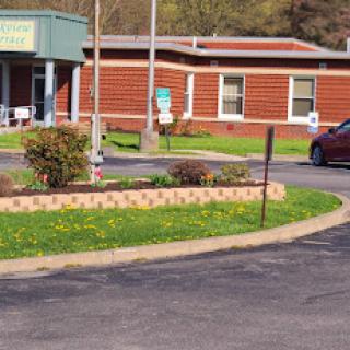 A community center with a well-maintained landscape and parking area.