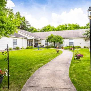 A serene house with a well-maintained garden and a winding pathway.