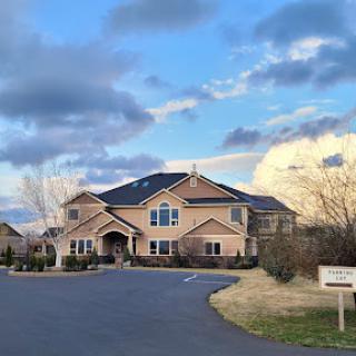 A beautiful suburban home set against a picturesque sky.