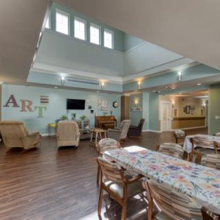 A spacious living area with comfortable seating and artistic decor.