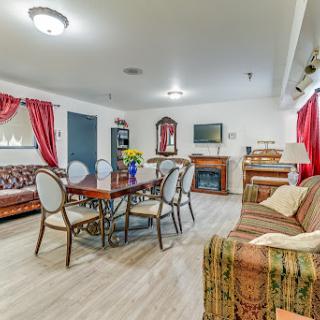 A cozy and well-designed living space featuring a dining area, comfortable seating, and vibrant decor.