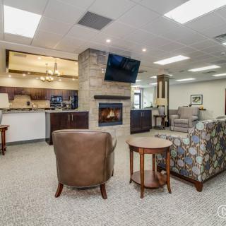 Spacious living area with a fireplace and open kitchen layout.
