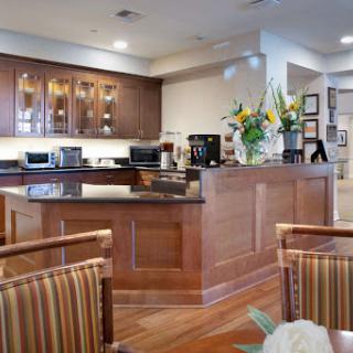 A beautifully designed modern kitchen featuring wooden cabinetry and vibrant floral arrangements.
