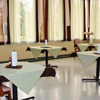 An empty restaurant dining area with neatly arranged tables and chairs.