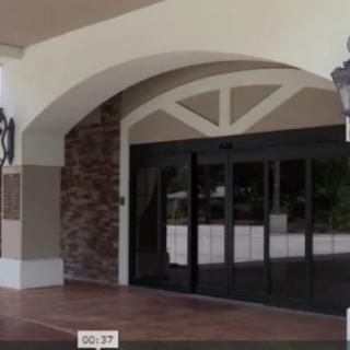 A building entrance with glass doors and an archway.