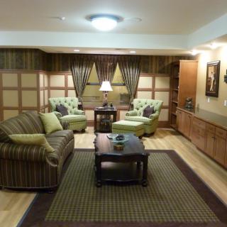 A cozy living room with comfortable seating and warm lighting.