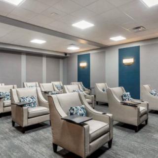A modern home theater room with luxurious seating arrangements and ambient lighting.