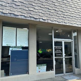 A storefront featuring multiple signs and a glass entrance.