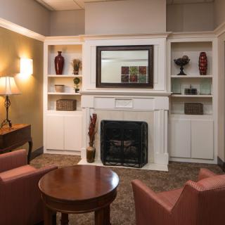 A cozy living room with a fireplace and comfortable seating.