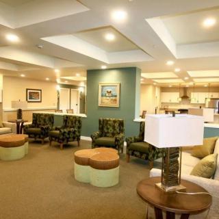 A spacious and modern living room with comfortable seating and stylish lighting.
