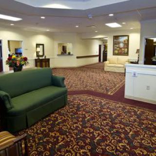 A spacious lobby with comfortable seating and a patterned carpet.