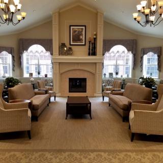 Elegant living room with a central fireplace and comfortable seating arrangement.
