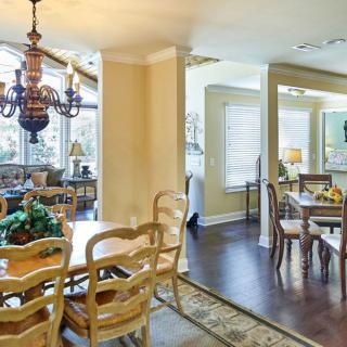 A cozy dining area with elegant wooden furniture and a vintage chandelier.