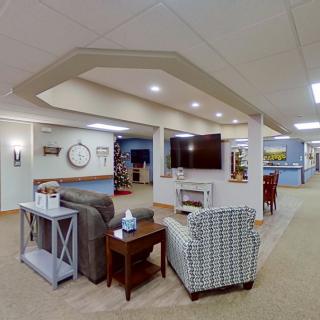 A cozy living room with comfortable seating and a large television.