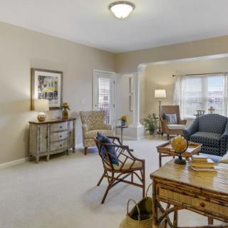 A spacious living room with comfortable seating and natural lighting.