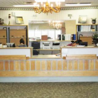 A reception area in an office with desks and office equipment.