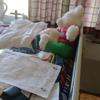 A cozy hospital scene featuring a stuffed bear and personal belongings.
