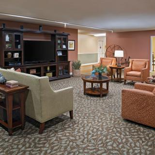 A cozy living room with comfortable seating and a large television.