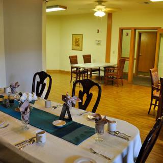 A neatly arranged dining table in a well-lit room with elegant chairs.
