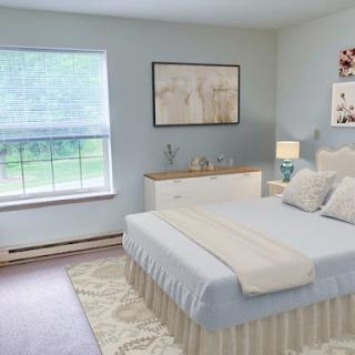 A serene and beautifully decorated bedroom featuring soft colors and minimalistic design.