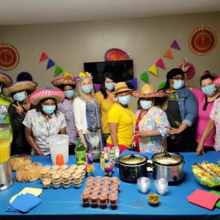 A lively gathering celebrating together with delicious food and festive attire.