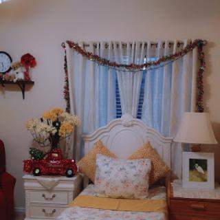 A cozy bedroom showcasing warm decor with floral accents and a charming toy truck.