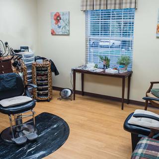 A cozy barbershop interior with chairs and a window view.