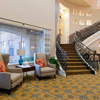 A welcoming lobby area featuring comfortable seating and an elegant staircase.