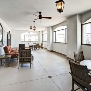 A spacious indoor lounge area with comfortable seating, large windows, and elegant lighting fixtures.