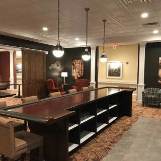 A spacious and elegantly decorated lounge area with comfortable seating and stylish lighting.