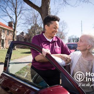 A caregiver providing assistance to an elderly individual, showcasing compassion and community support.