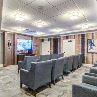 A cozy home theater with plush seating and a large screen.