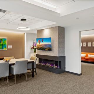 A modern office interior with a conference table and cozy fireplace.